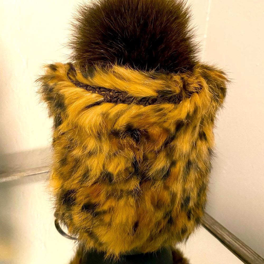 Never worn hat with Pom Pom. Rich brown and fur to keep your head warm.
